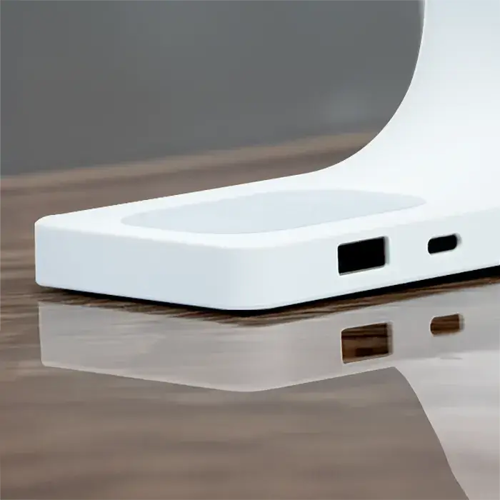 White Simpli MagSafe charger base with USB output port on wooden desk