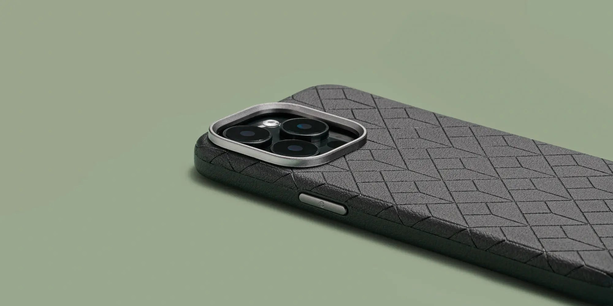 Essentia MagSafe Case in Ebony showcasing its geometric texture, raised camera protection, and sleek, non-slip design for iPhone 15 series.