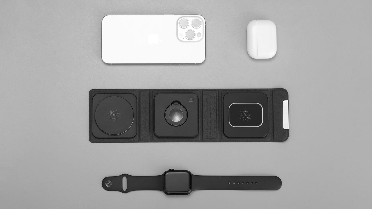 Top view of Modern Standard's CUBICA MagSafe charging mat with slots for iPhone, AirPods, and Apple Watch, highlighting organized and efficient multi-device charging on a sleek black mat.