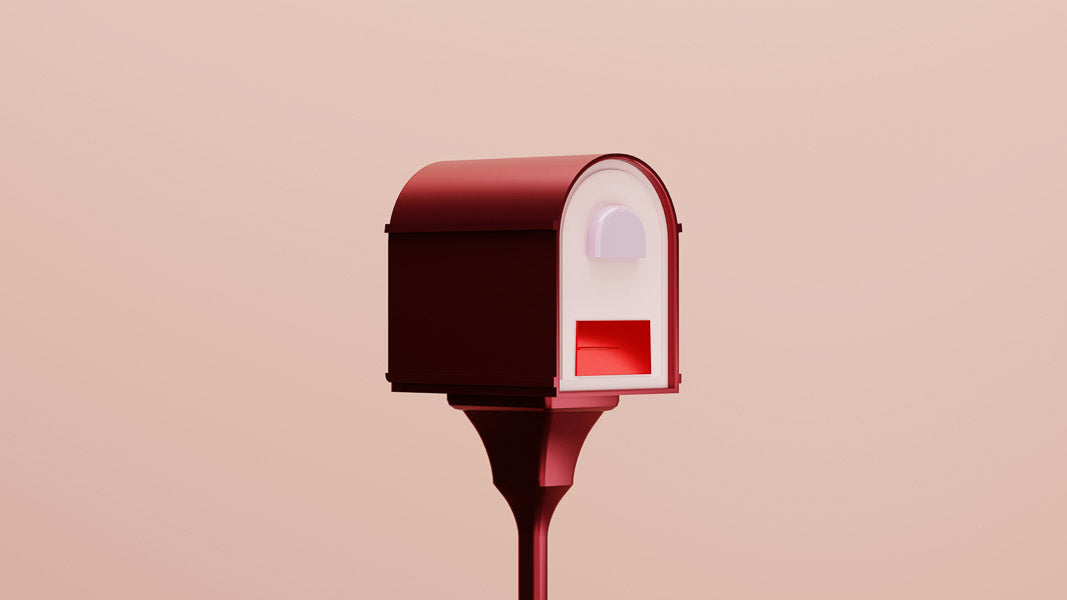 Minimalist red mailbox on a pastel pink background, symbolizing delivery and communication, ideal for use in topics related to shipping, postal services, and online purchases.